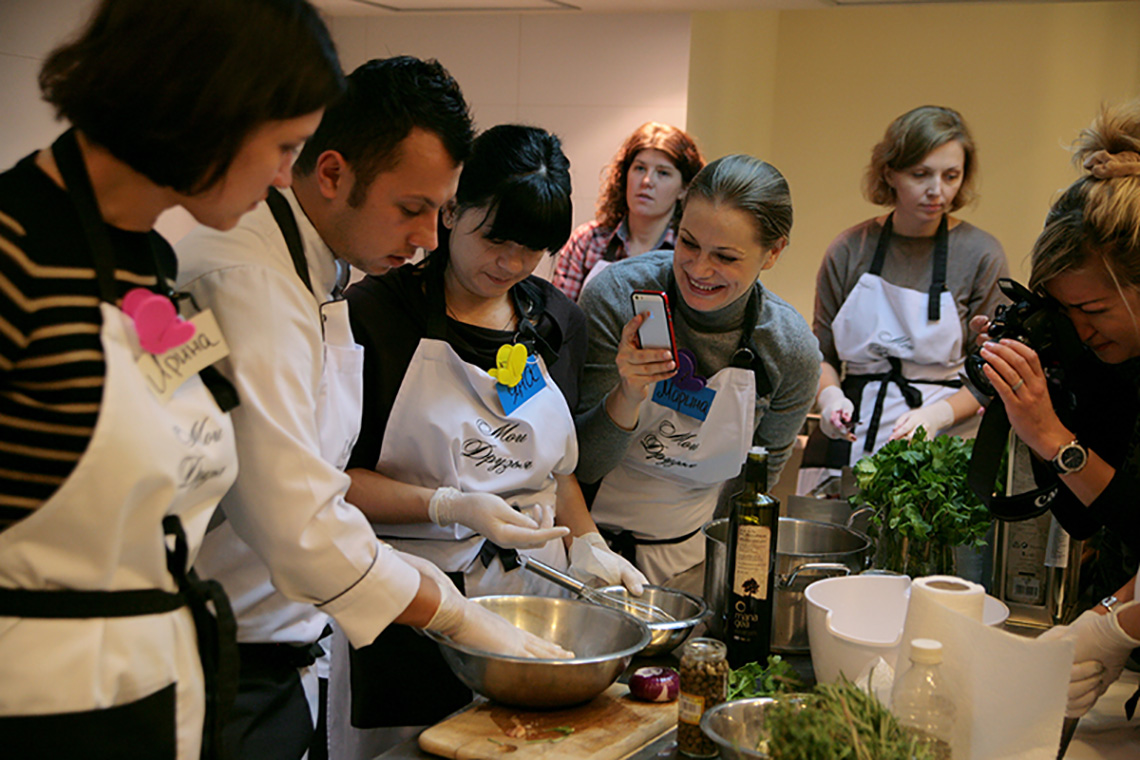 Participants and chef. Olive oil tasting during lesson "Greek Сuisine". Cooking classes in Ukraine.