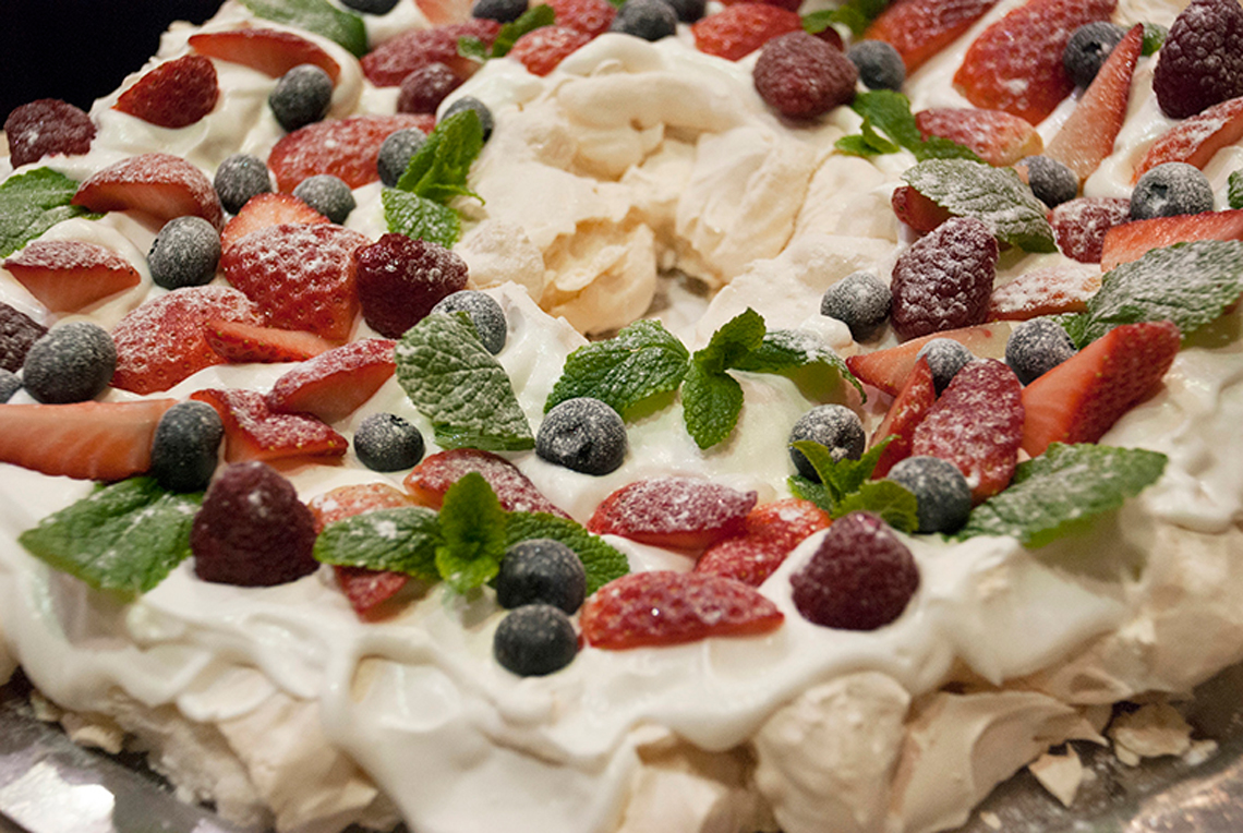 Dessert with berries. Christmas Dessert Pavlova Wreath.